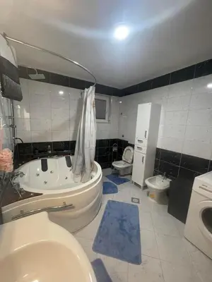a bathroom with a tub and a toilet and a sink at Porodični mir in Bugojno