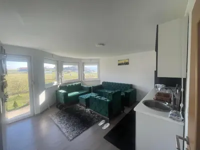 a living room with a couch and a sink at Porodični mir in Bugojno