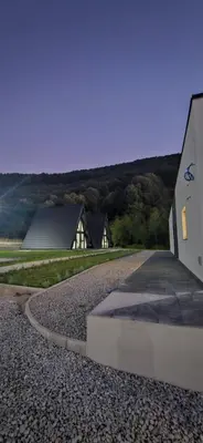 a house and a road next to a building at Golden Spa A-Frame 2 in Bihać