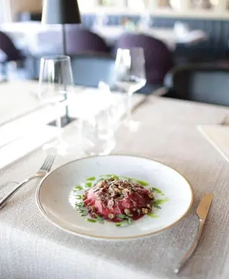 a plate of food sitting on a table at Boutique Hotel St Georgije in Banja Luka