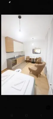a room with a bed and a table and chairs at NM Apartman in Banja Luka