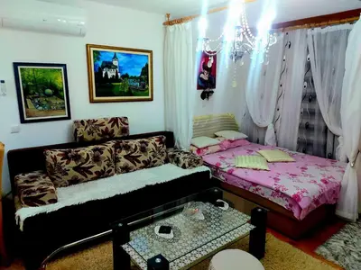 a living room with a couch and a bed at Apartman Fantasy Zavidovici in Zavidovići