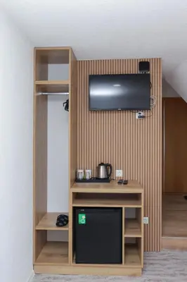 a room with a tv on a wall at Pansion A&M Vlašić in Vlasic