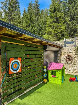 a backyard with a climbing wall and a play house at Vila Bašić Vlašić Spa Apartman JELEN in Vlasic