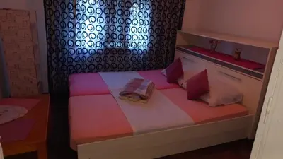 a small room with a bed with a book on it at Family house in Visoko