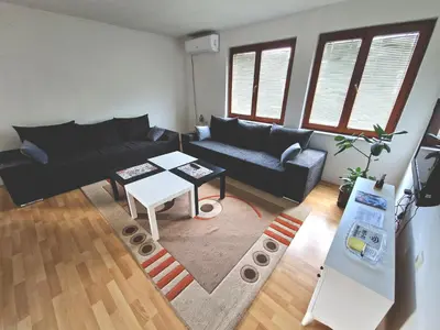 a living room with a couch and a table at Apartman Komfor in Banja Luka