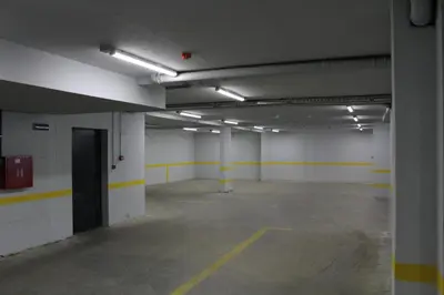 an empty parking garage with yellow and white walls at VIP 2 Apartment in Visoko