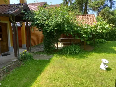 a teddy bear sitting in the grass in a yard at Soba Dujaković in Banja Vrućica